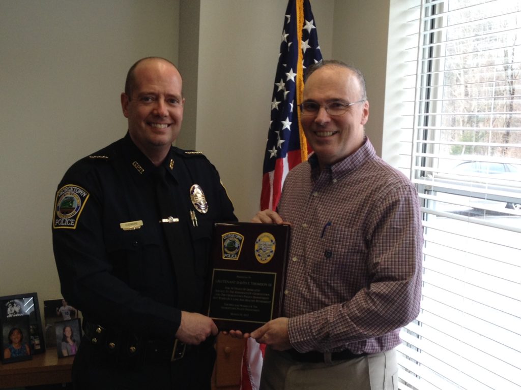 Chief Cudmore (left) congratulates retiring Lieutenant David F. Thomson III. (Georgetown Police Courtesy Photo)