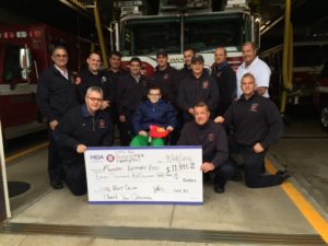 Front row, from left to right: Firefighter Jim Hannon, Sebastian Hansen, Firefighter Josh Severence, Firefighter Bruce Wonson and Firefighter Chad Mota. Back row, from left to right: Asst. Chief Tom Aiello, Firefighter Andrew Lyons, Lt. Buddy Doucette, Capt. Joe Aiello, Firefighter Joe Johnson, Firefighter David Barrett, Firefighter Paul Hudson, and Deputy Chief Andrew McRobb. (Courtesy Photo)