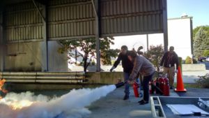 Anthony Laber, Occupational Hygienist at Chesterton, left, guided Sandy Sheehan, of Groveland, through fire extinguisher training yesterday. (Courtesy Photo)