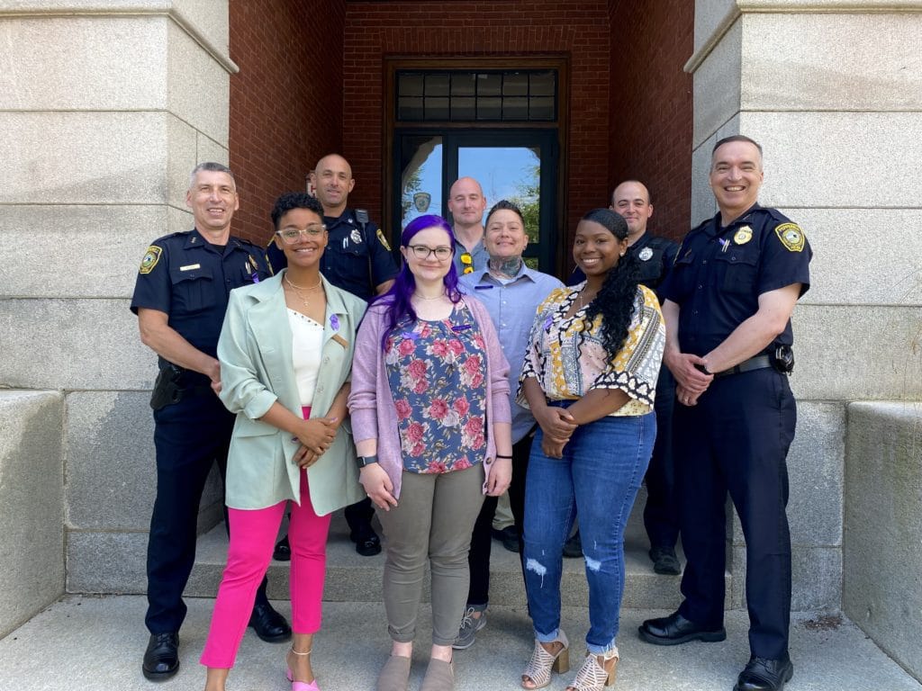 Front row, from left: Camila Lopez, Natalie Bergeron-Tarmey, Sarah Anderson and Kareen St. Vil. Back row, from left: Deputy Police Chief Todd Blain, Officer Jared Carrubba, Detective John Coburn, Office Mike Kenney and Police Chief David Scott. (Courtesy Photo Alternative House)