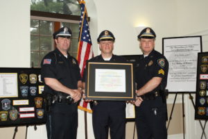 Left-to-Right, Officer Keith Sheppart, Lieutenant Thomas Browne, the department's accreditation manager, and Sergeant Timothy McDonough receive the Accreditation Award.